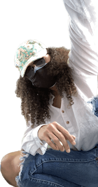 a woman wearing a hat and jeans