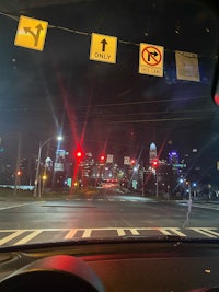 a car driving down a city street at night